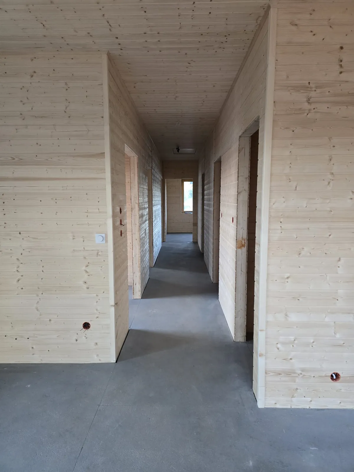 Korytarz w domu szkieletowym 86 m² obity drewnianą deską